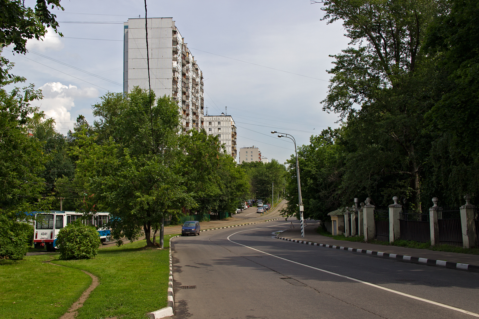 a long stretch of road in front of tall buildings