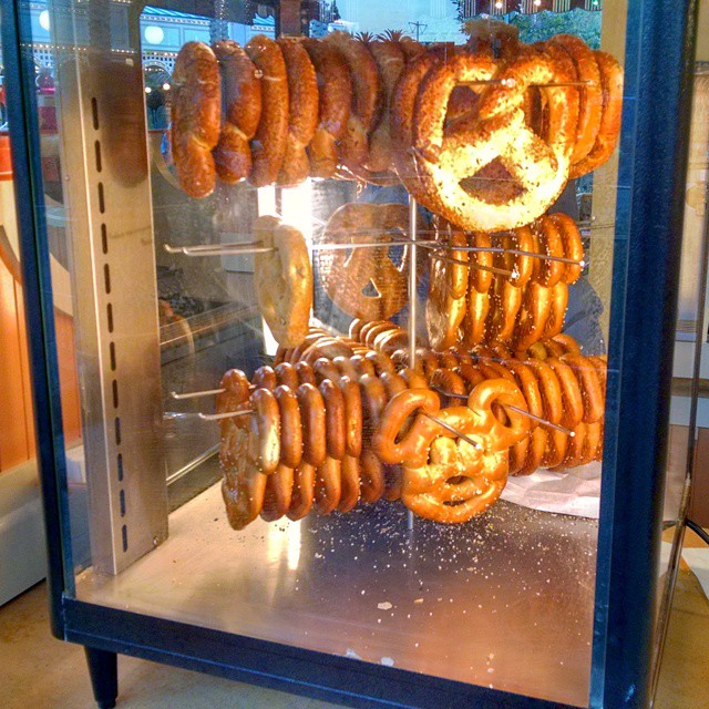 a rack full of donuts sitting in front of a glass
