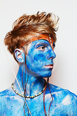 a man with painted blue is posing for a po