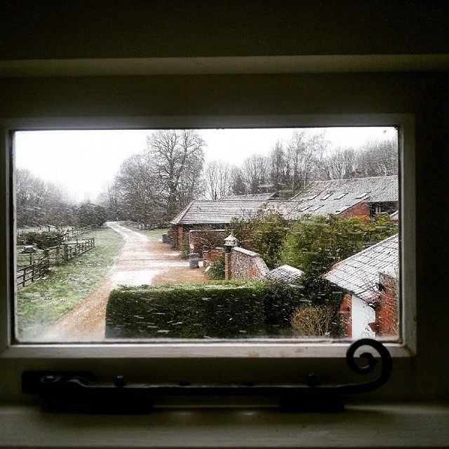 an open window with snow on the outside of it