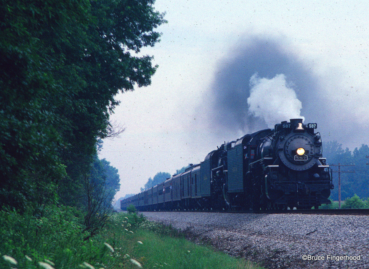 an old locomotive in motion on a railway tracks