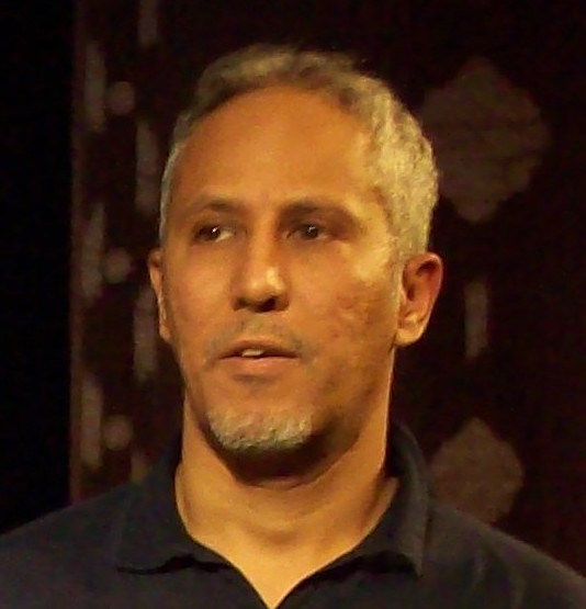a man with grey hair and a black shirt