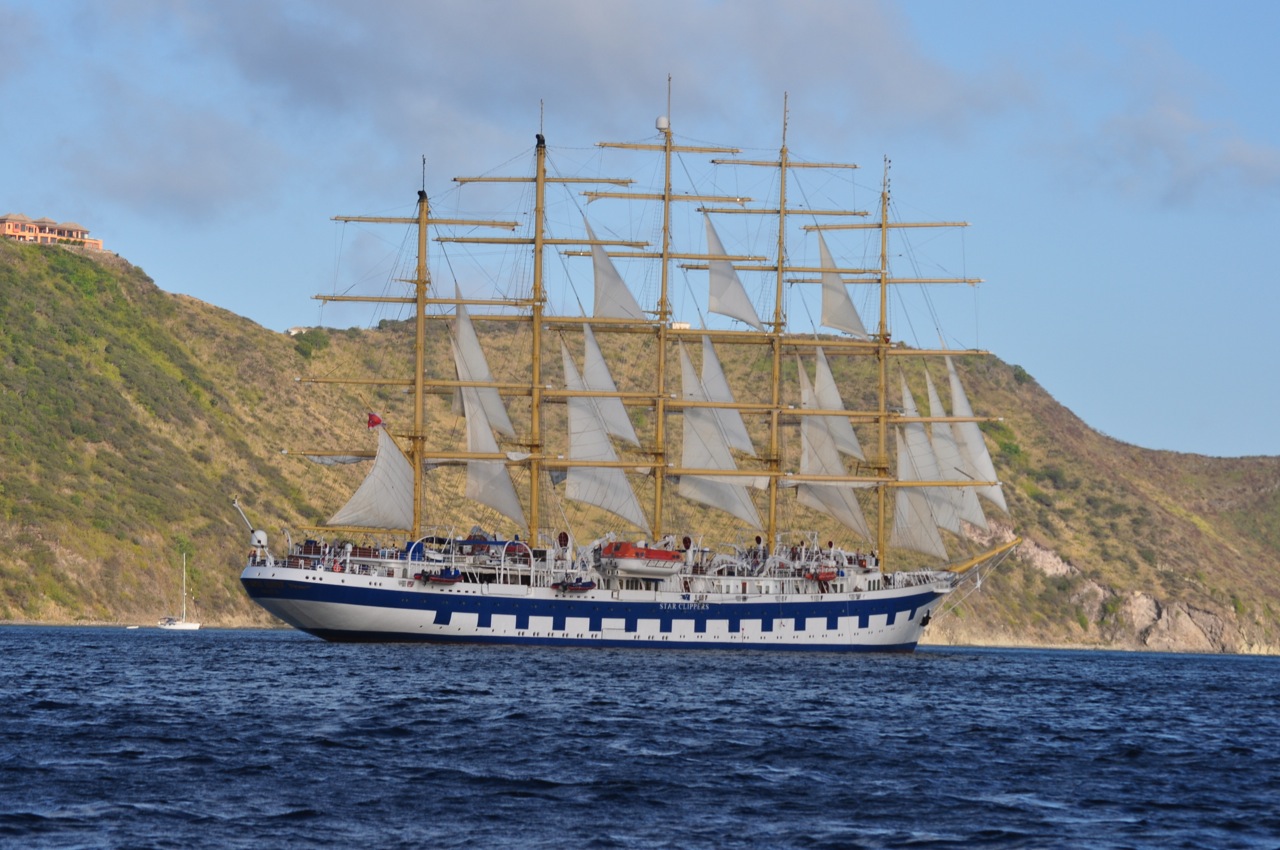 a sailboat in the water with some people on board