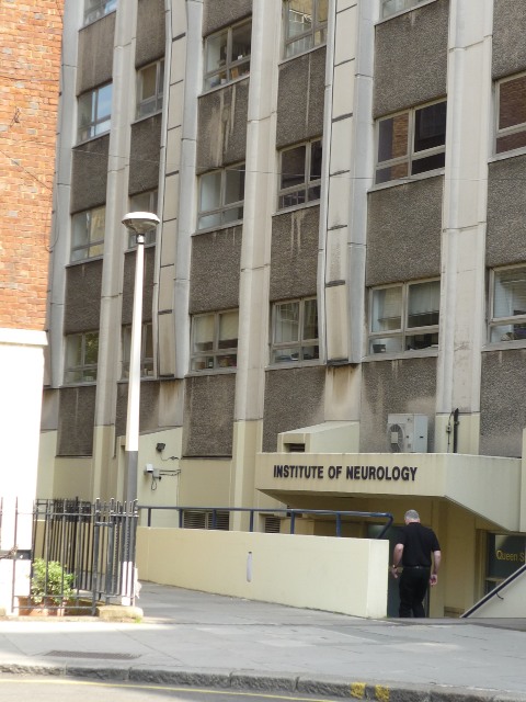 a man walking past an entrance to a building