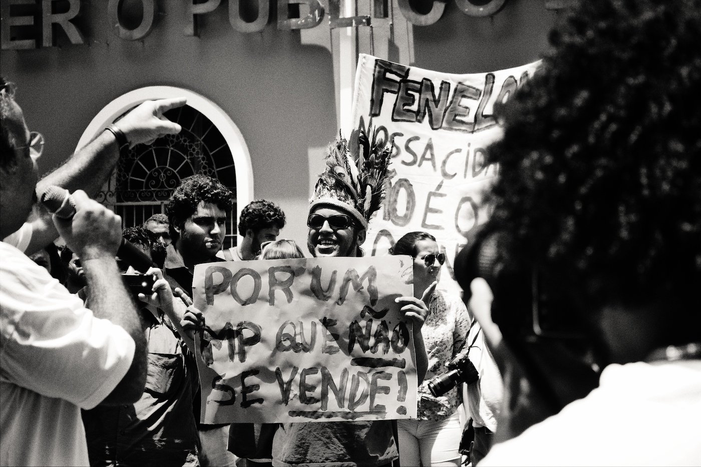 some people holding signs in front of a building