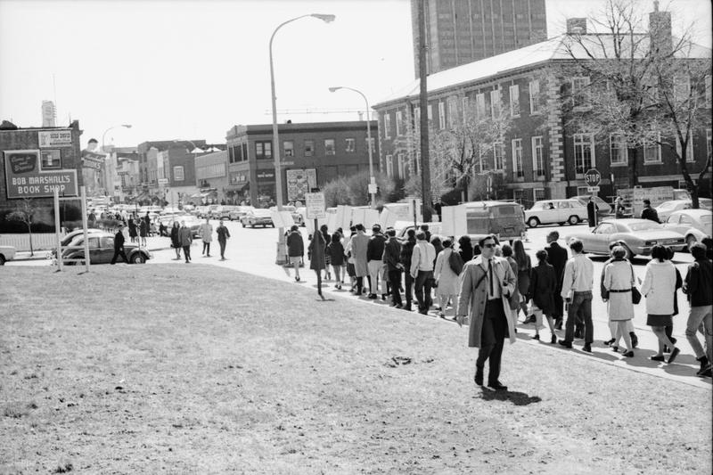 there is a large group of people walking down the street