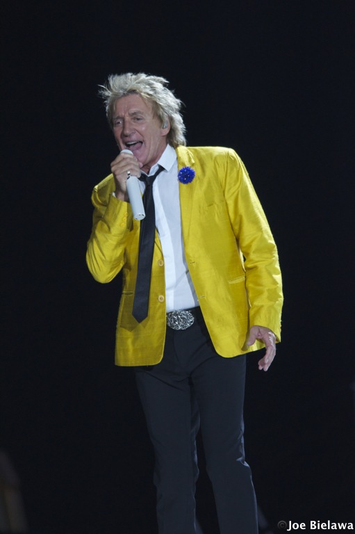a man standing with a yellow blazer on