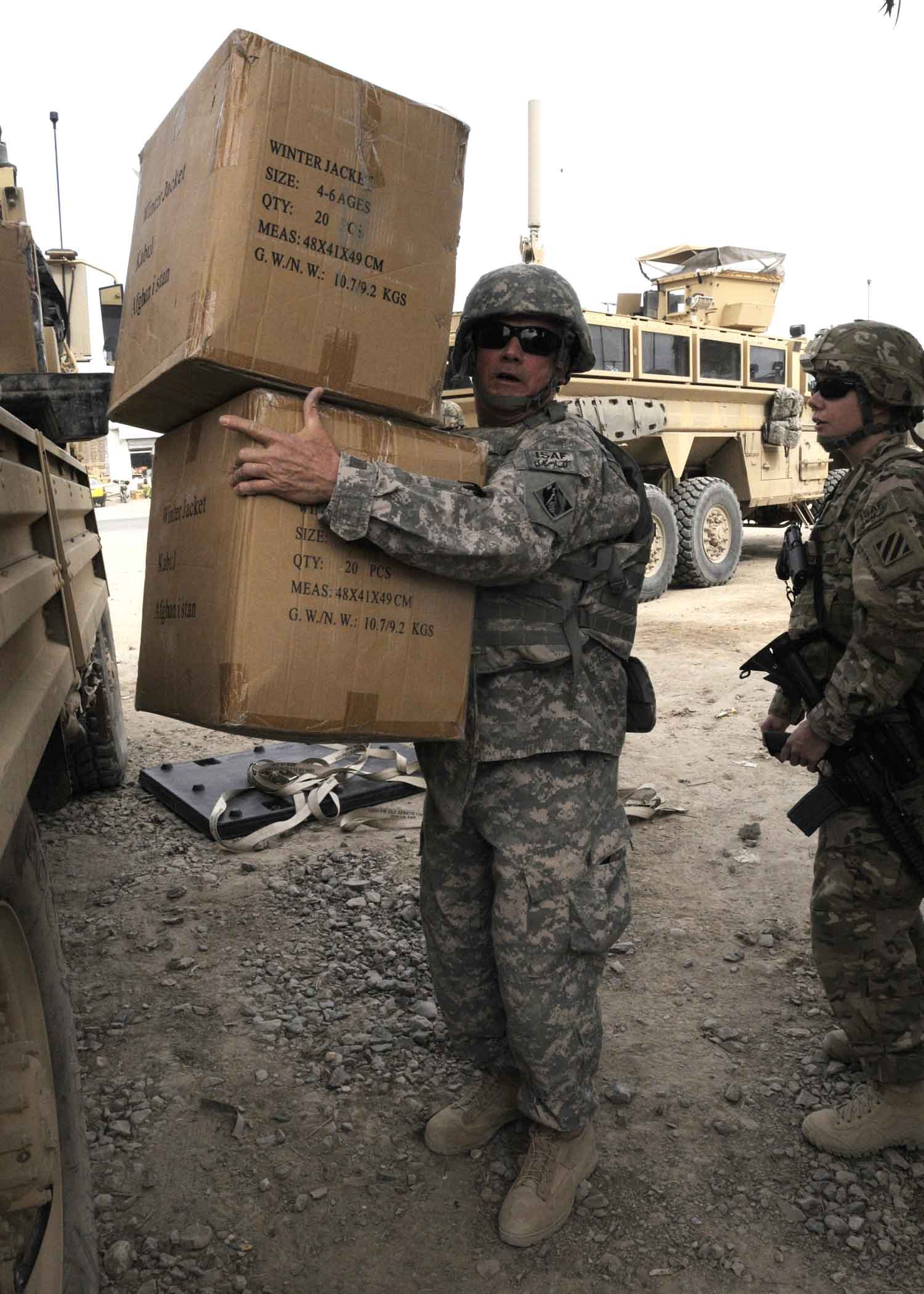 a soldier is carrying some boxes with a message on it