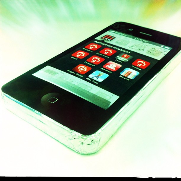 a white cell phone with red icons on the screen