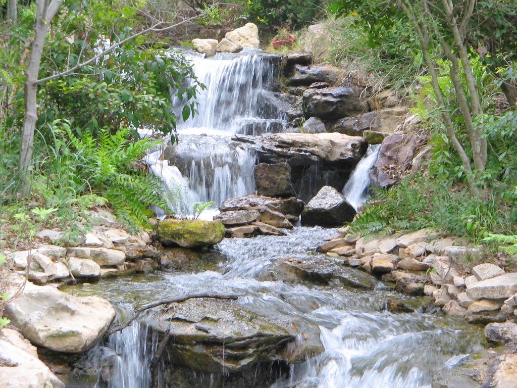 a large waterfall with many small rocks