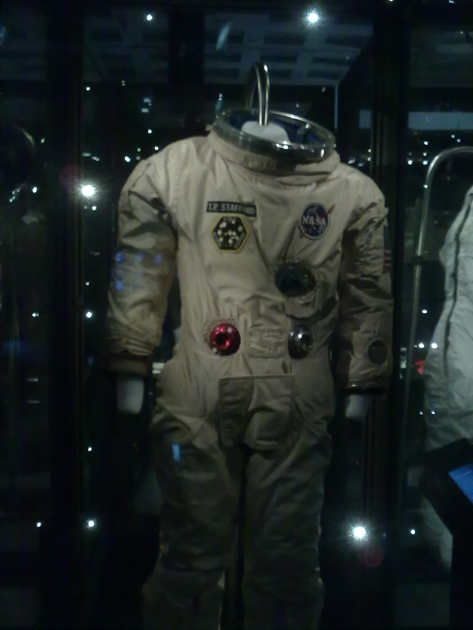 an astronaut suit sitting next to another astronaut suit