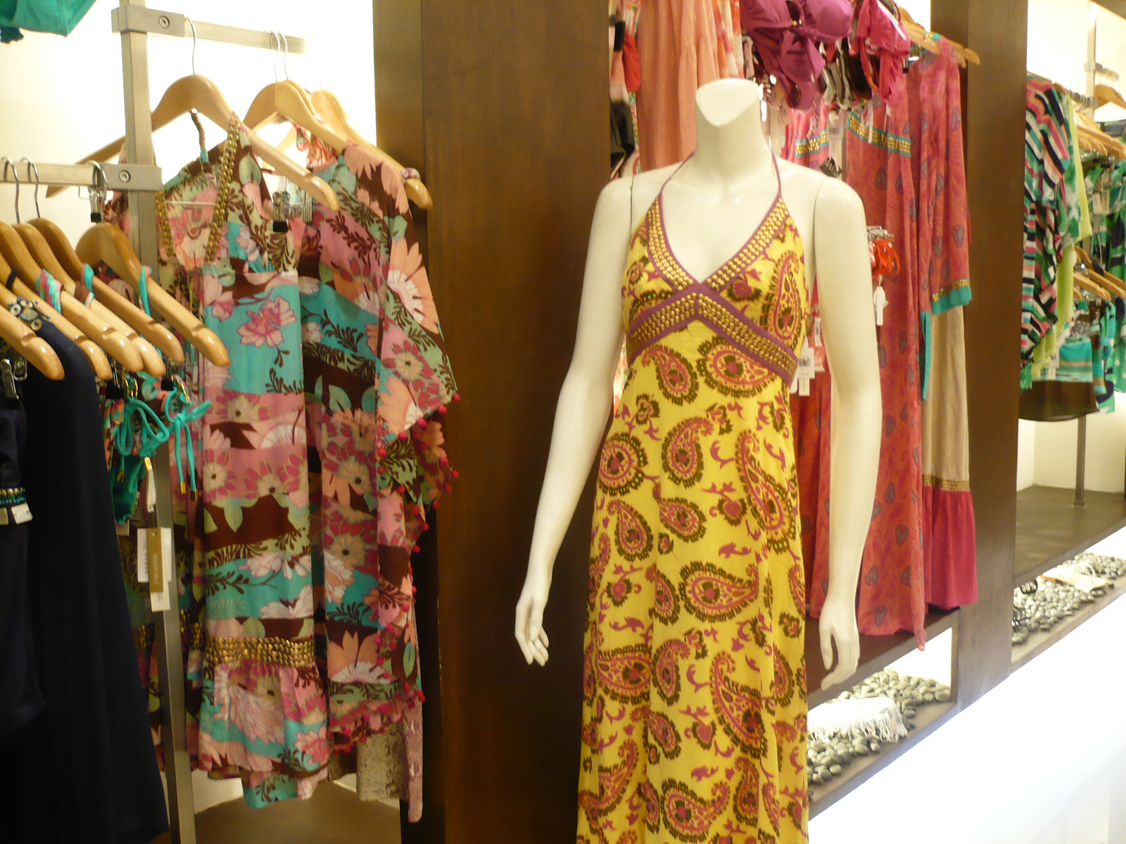 a display case with several shirts and dresses in a store