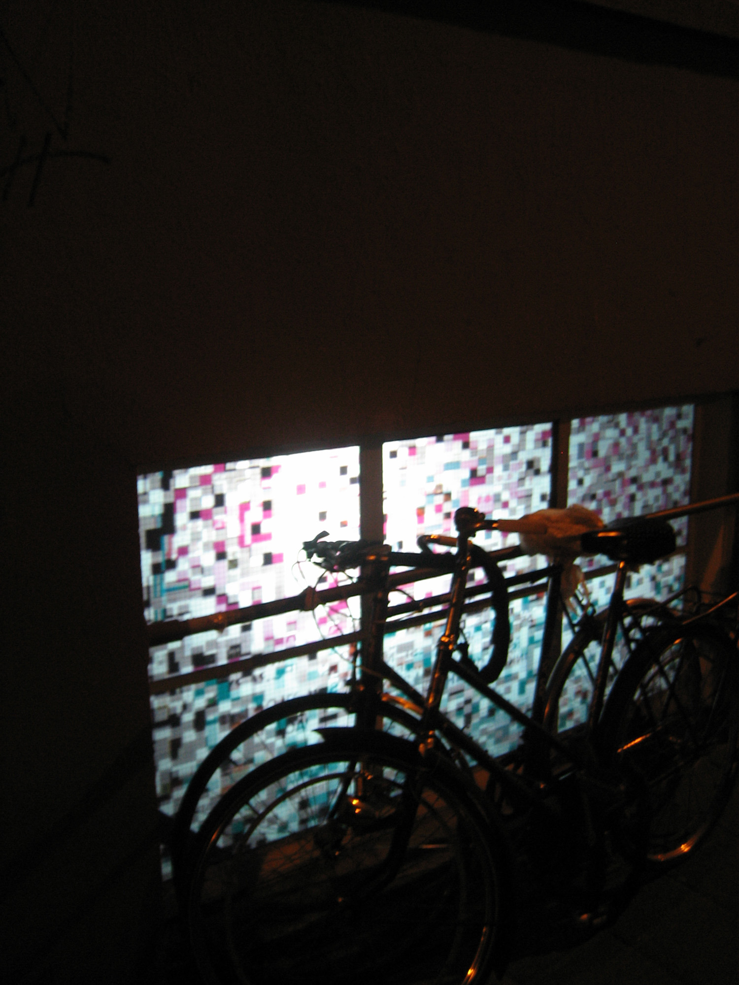 the window has many bicycles on it outside