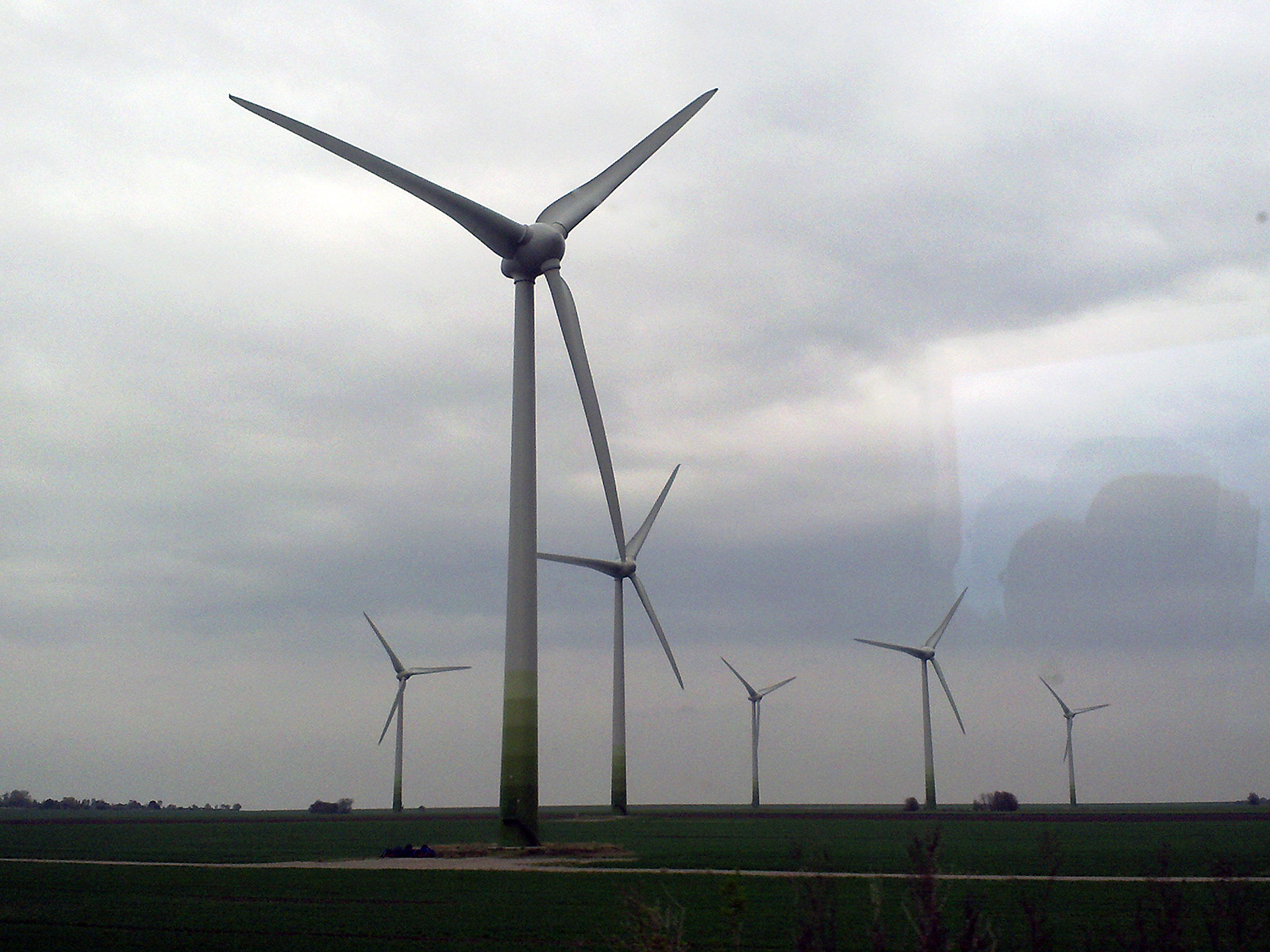 wind turbines on a field with a sky background