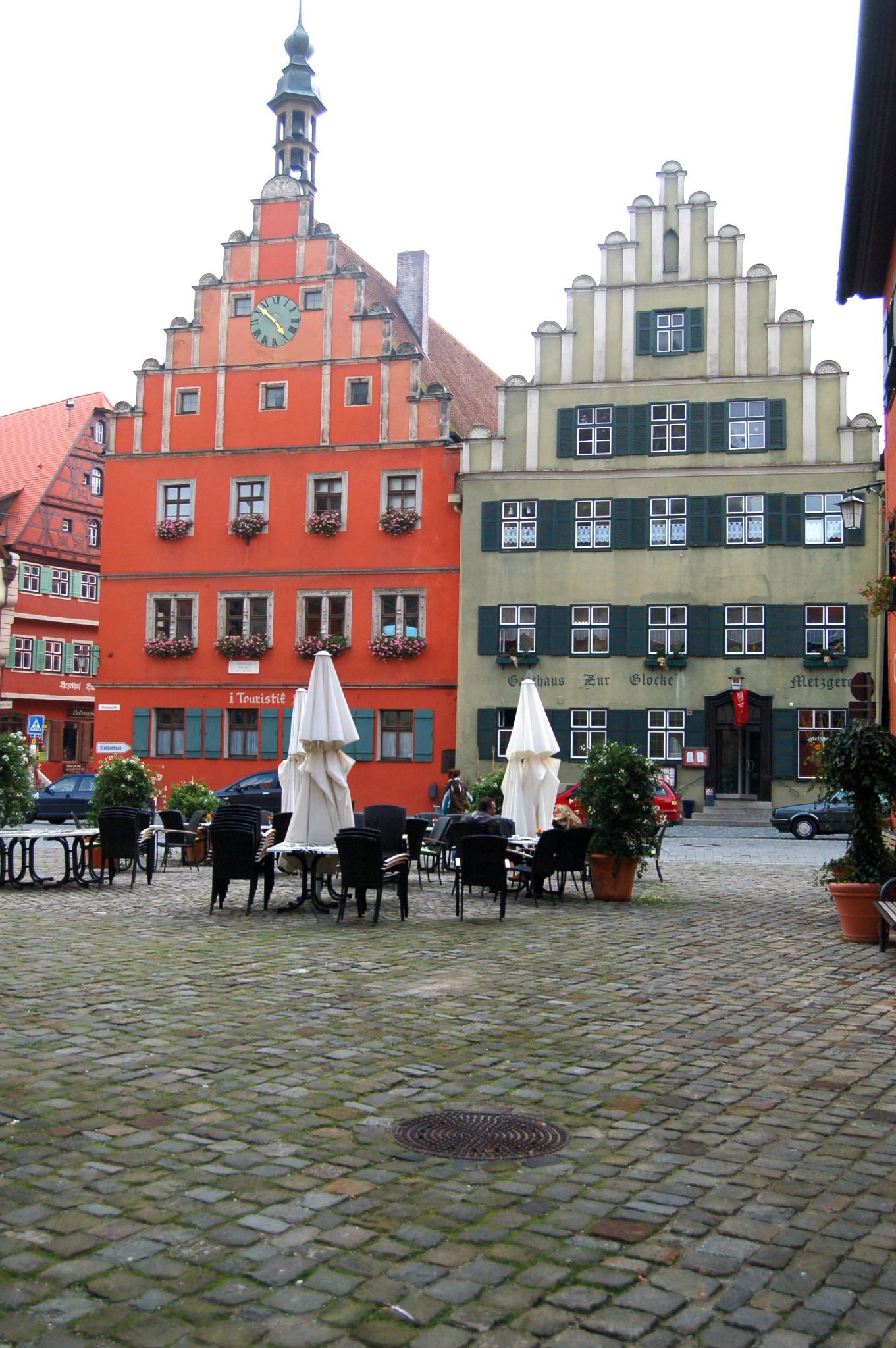 several chairs sitting in a row outside on a bricked patio