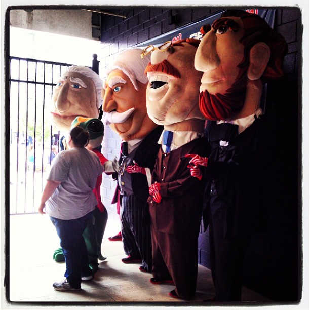 some people wearing creepy costumes are standing in front of a wall