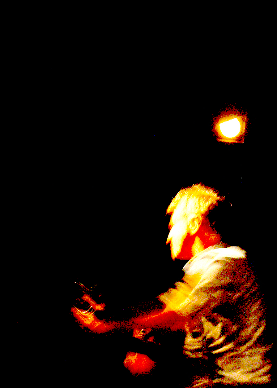 a man holding a red object in the dark