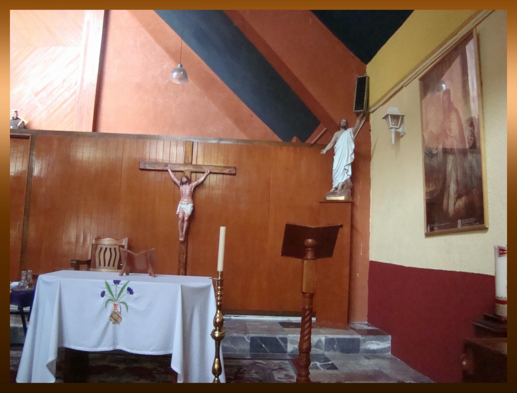 a small dining area with wood paneled walls and a crucifix