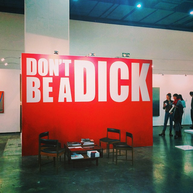 a large don't be a  sign is displayed in an art gallery