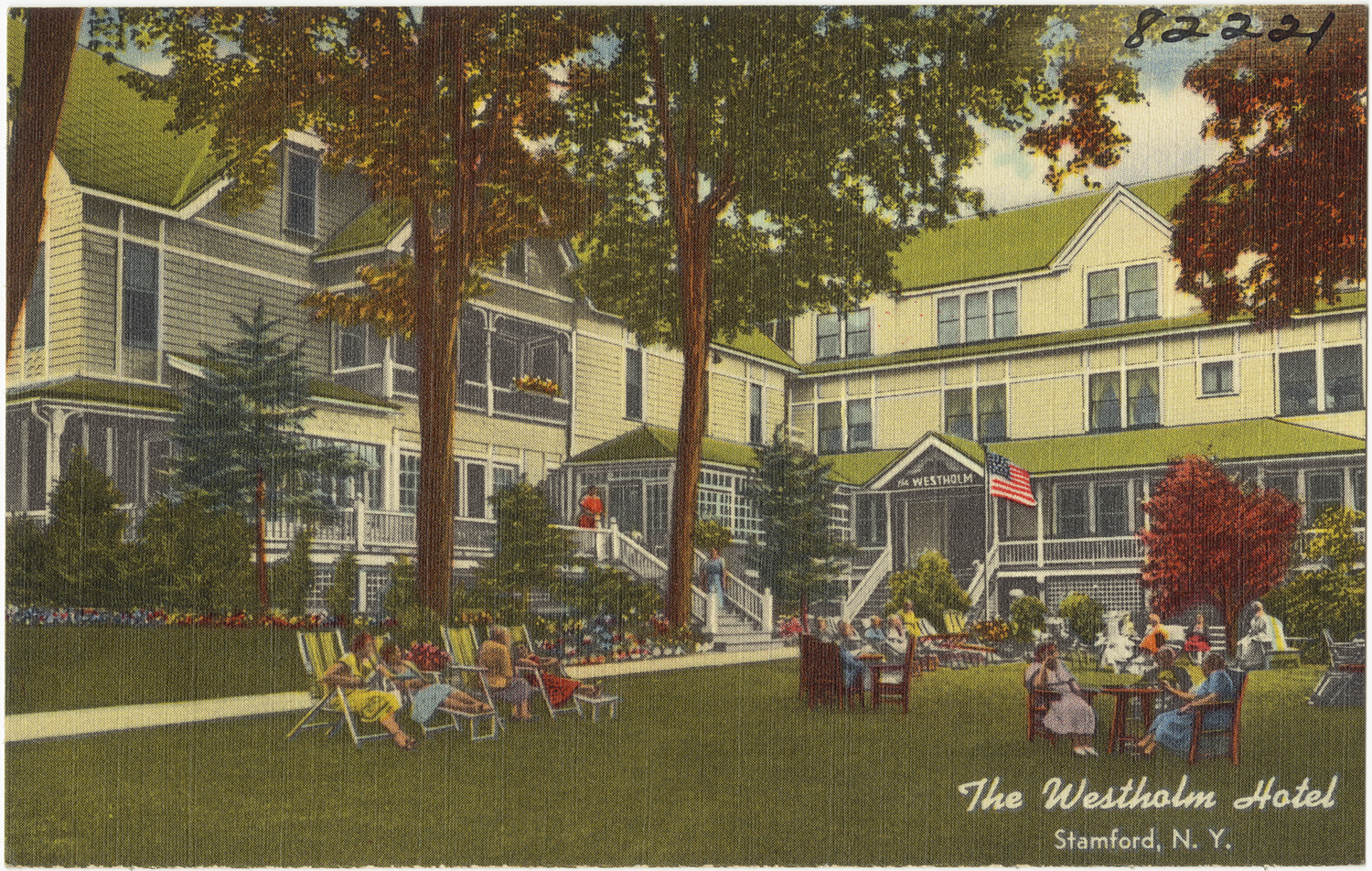 a large building with a large tree on the corner