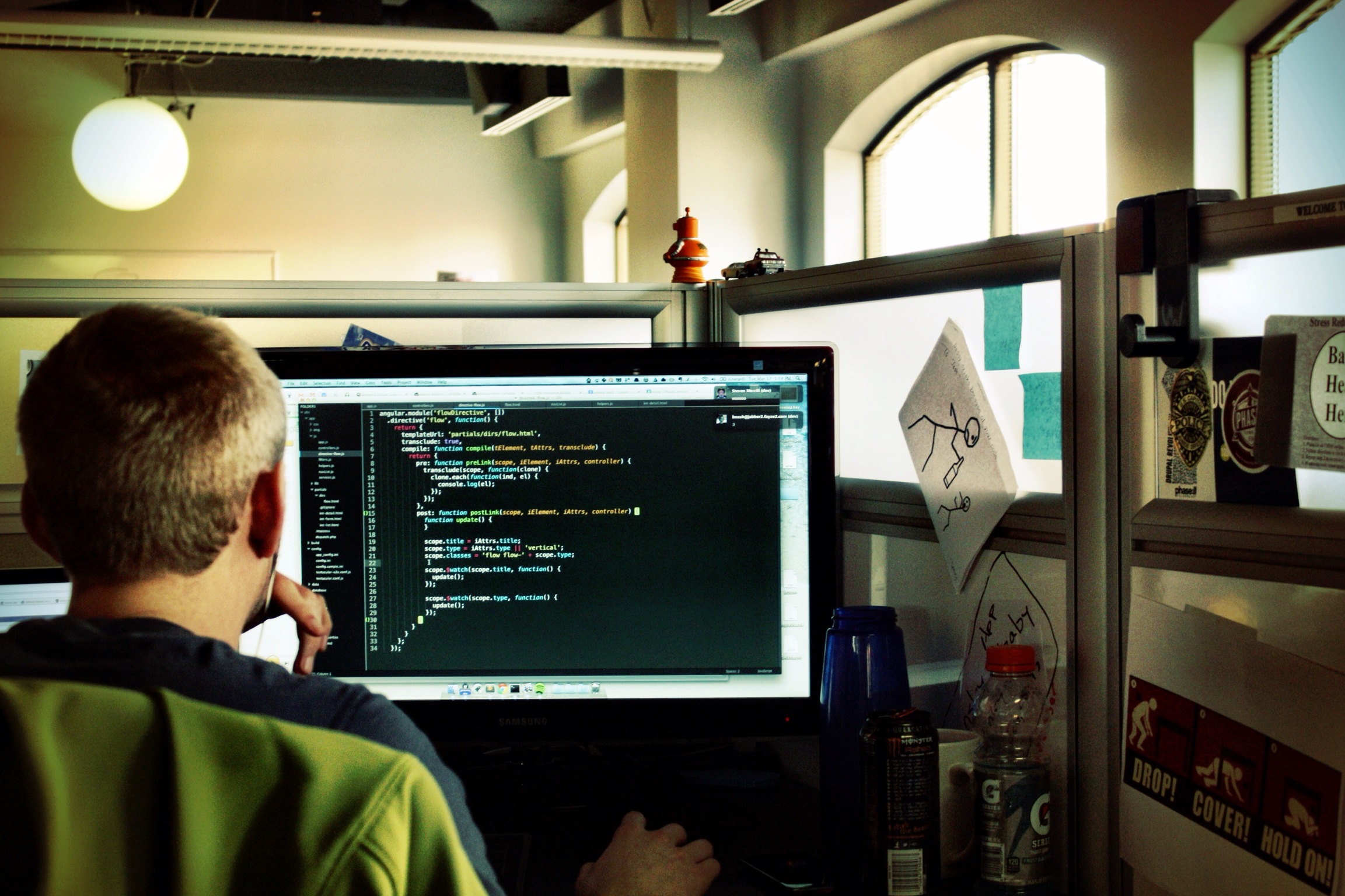 a person sitting at a desk on his computer