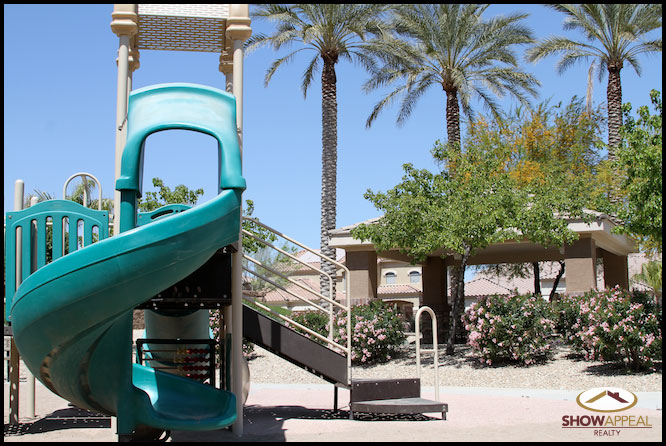 a blue and white water slide next to palm trees