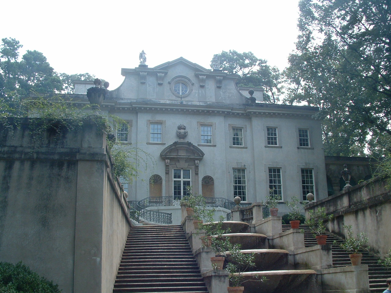 a mansion with stairs leading to the upper floor and the second floor