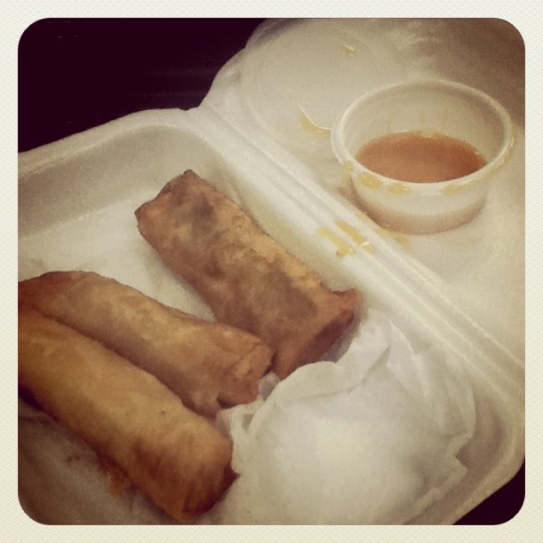 an empty styrofoam container filled with three different type of food