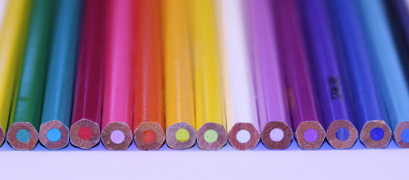 pencils arranged in rainbow colours are lined up