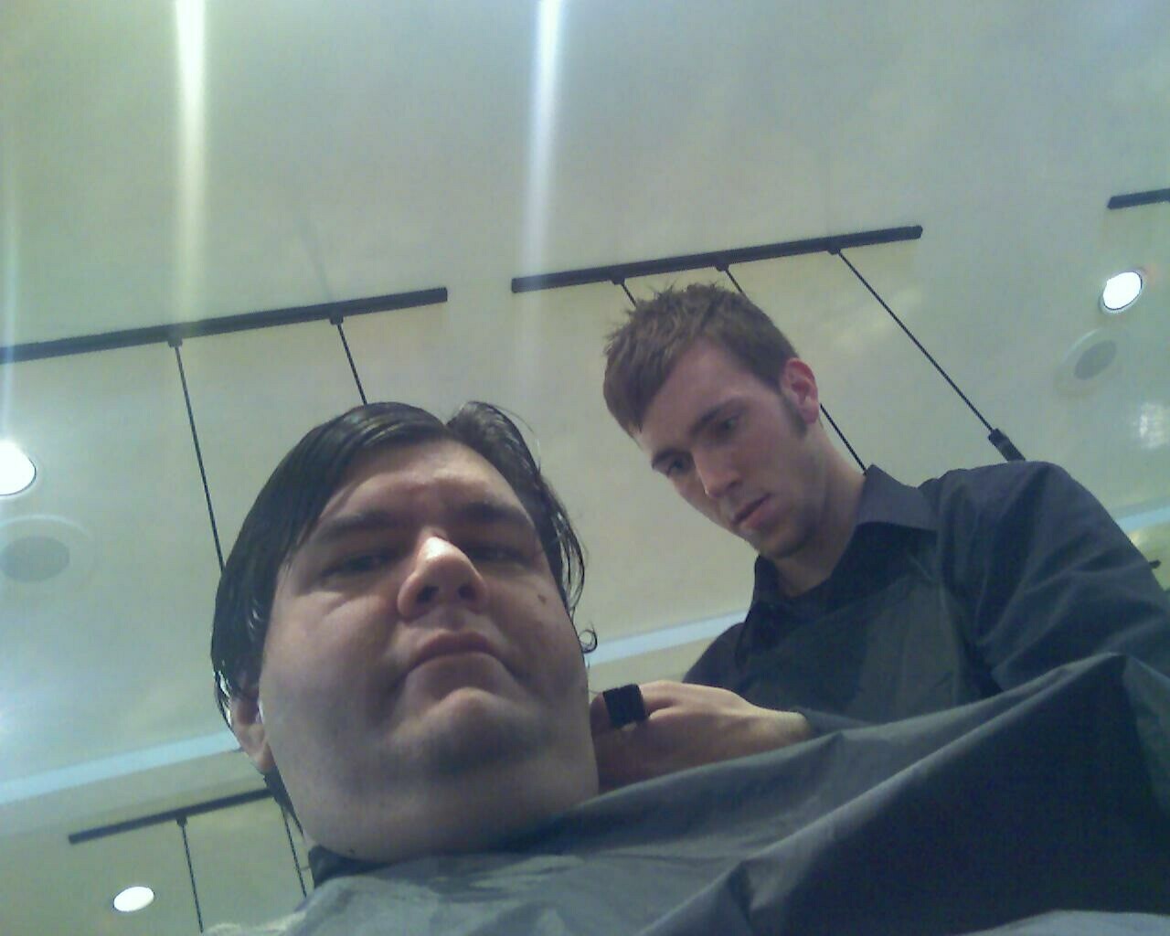 a man with a beard getting his hair cut