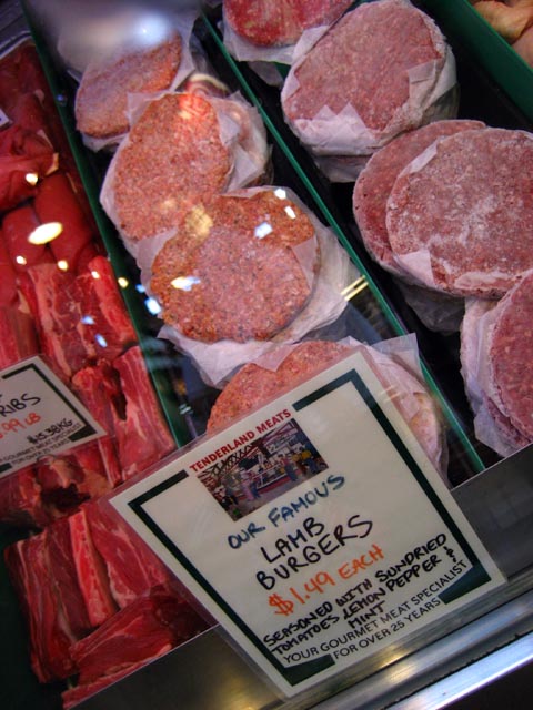 meat and bread products on display for sale at a market