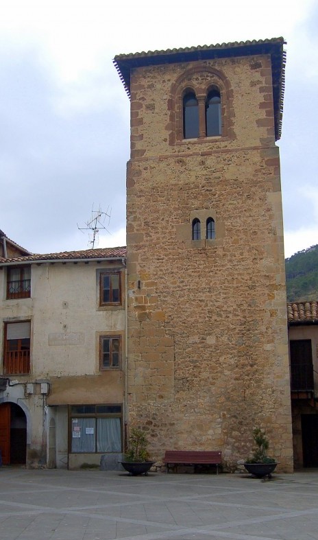 an old stone building with a very tall tower