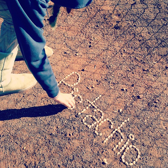 a close up of a person writing on the ground