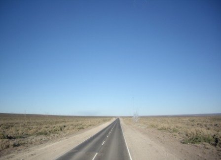 an empty highway is shown with the view of the sky