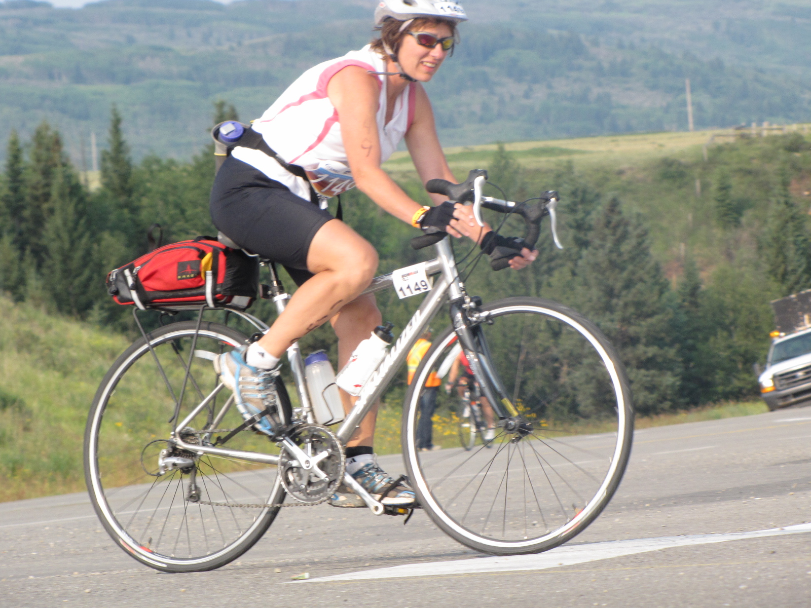 a woman riding her bike on the road