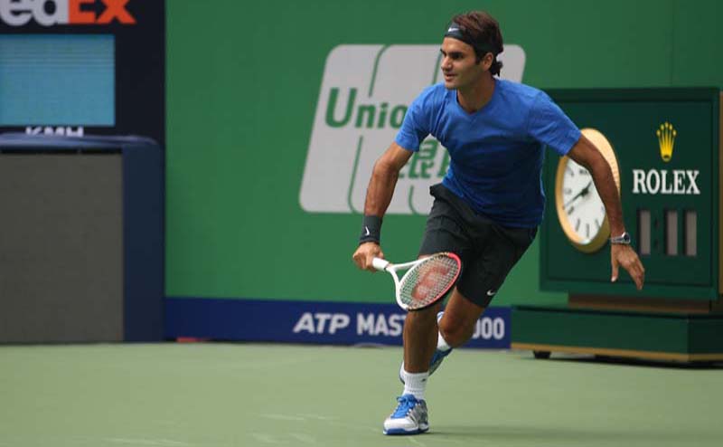 a man running towards the tennis ball during a game