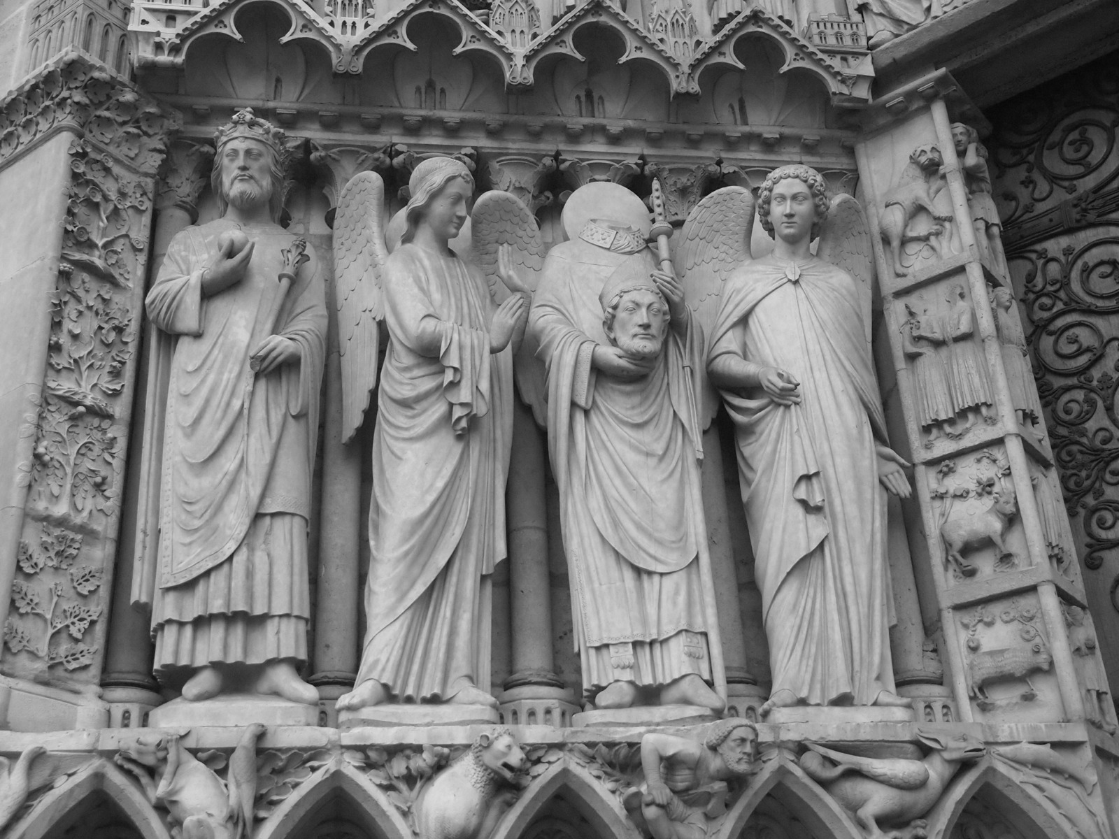 black and white pograph of statues on an ancient building