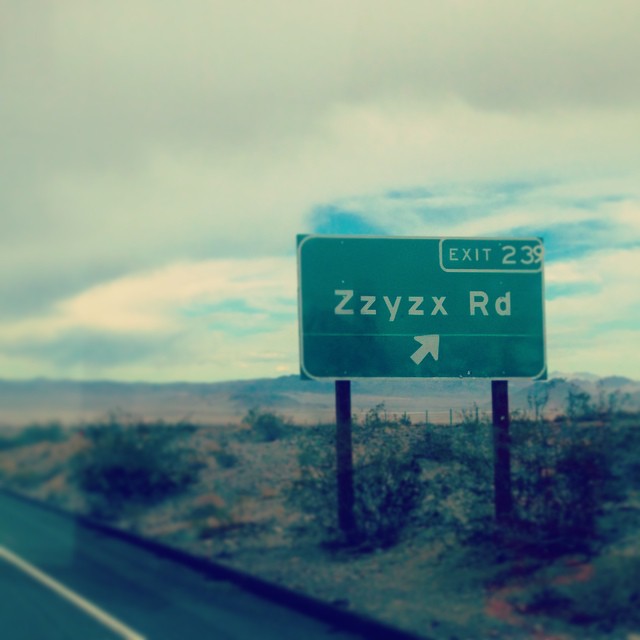 a street sign with an exit for zzyzzyx road below