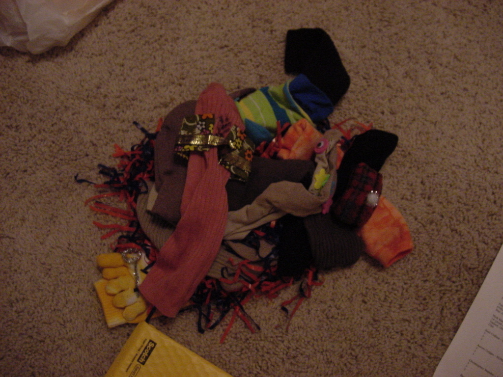 a pile of clothing and socks on the floor