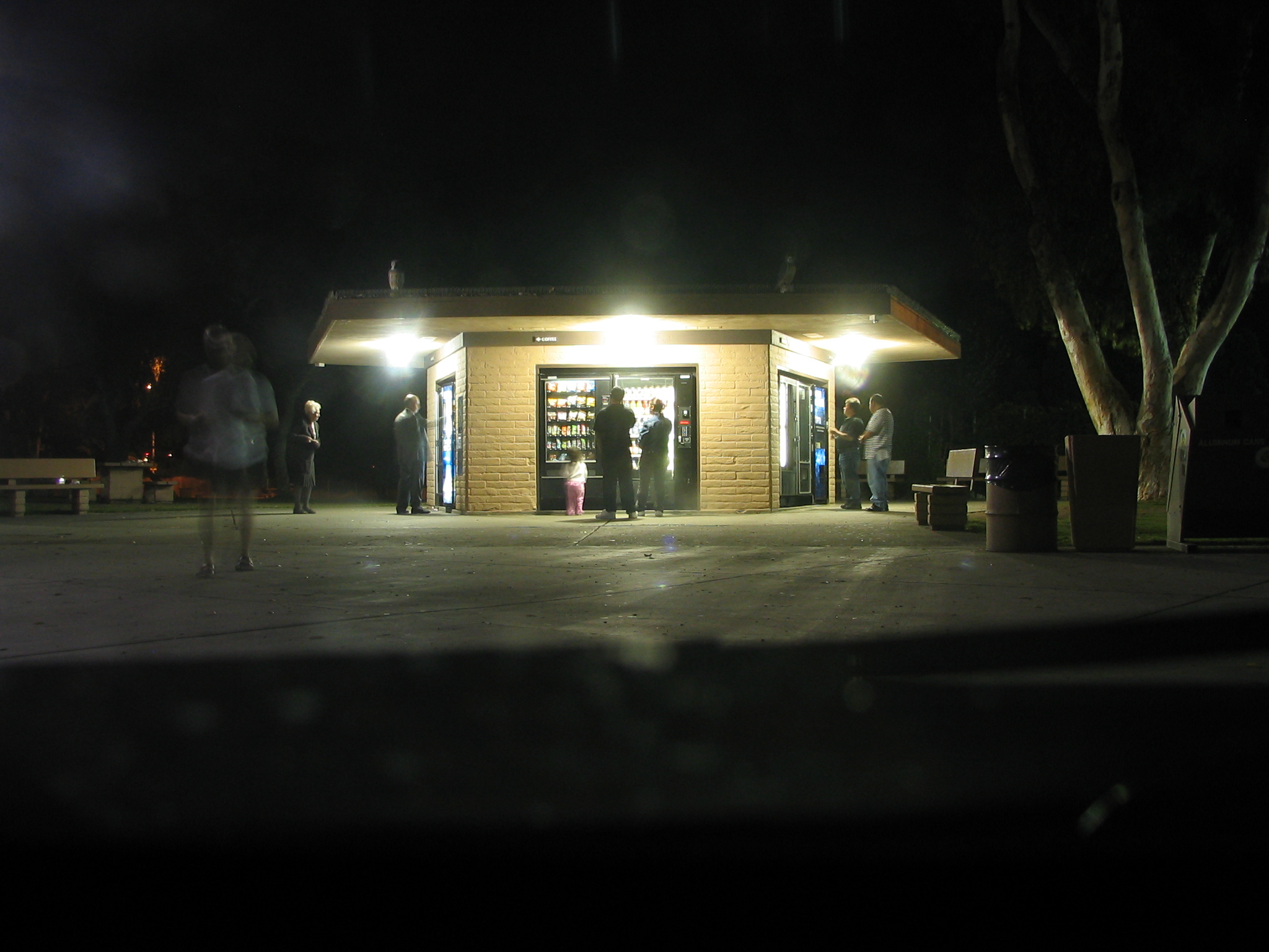 a small building lit up by street lights