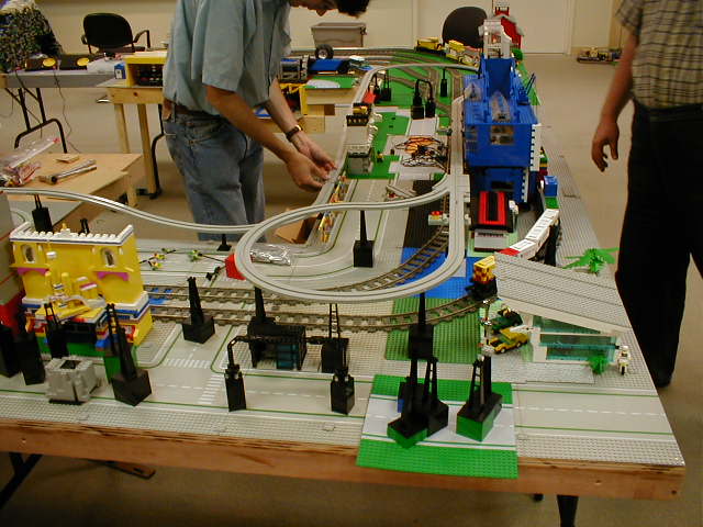 two people working on a model train set