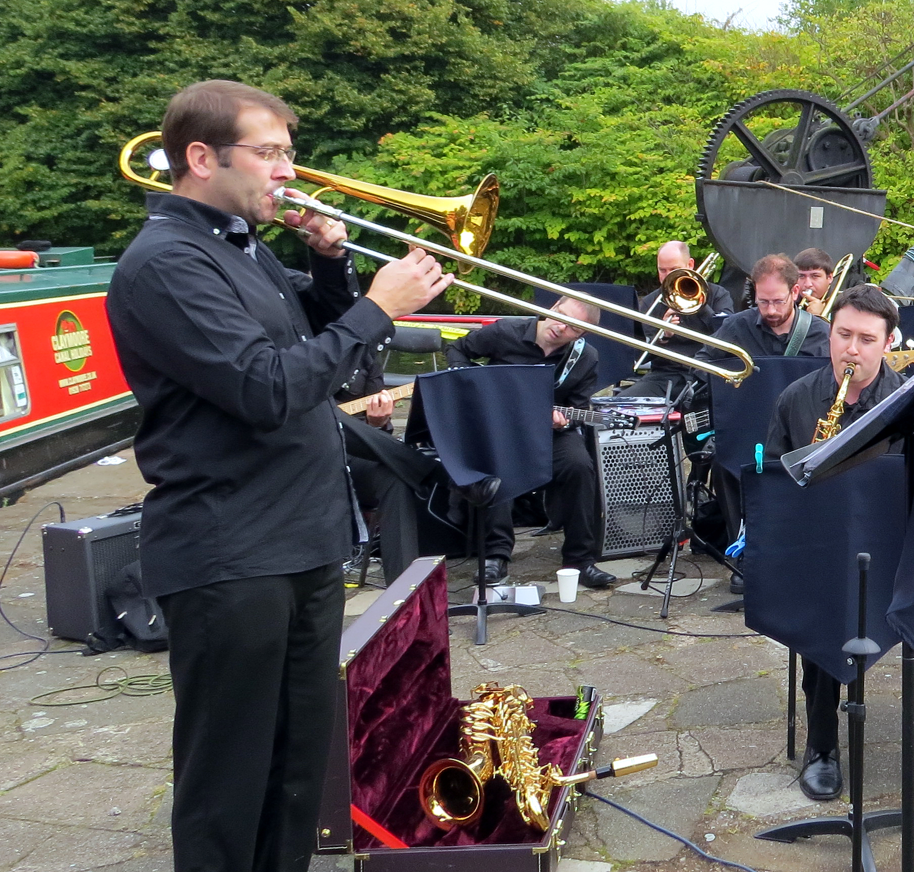 a band with musicians standing in front of a train car