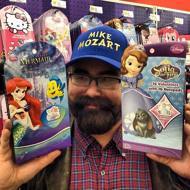 a man holding three boxes of animation characters