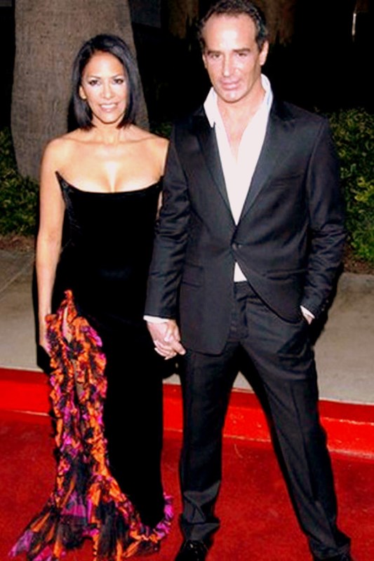 an image of a man and woman holding hands on the red carpet