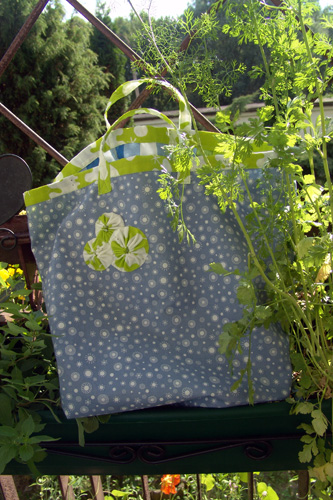 a bag hanging over a bench and other plants