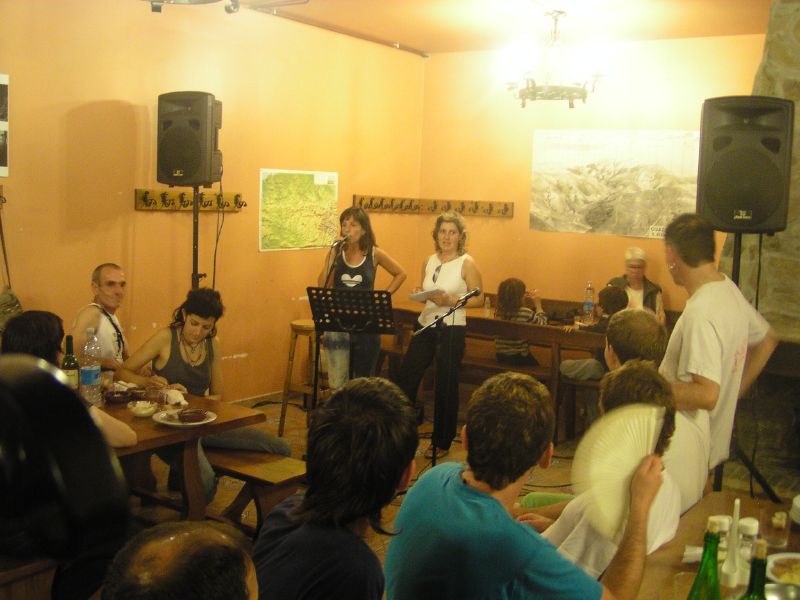 a group of people sitting at tables with a microphone