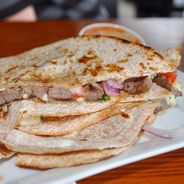 two meat quesadillas stacked on a plate