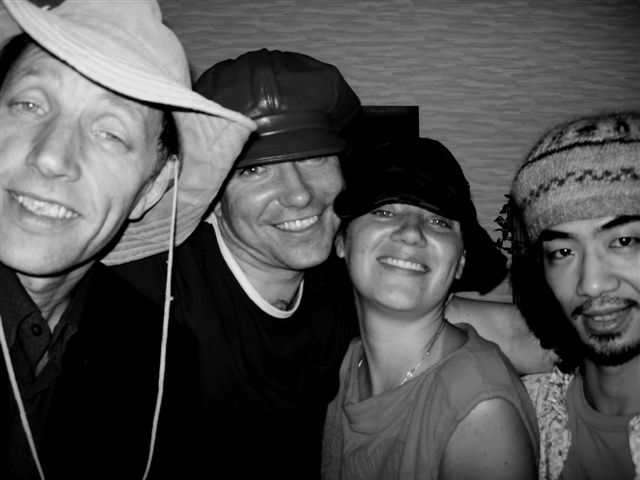 a black and white po of four people with hats