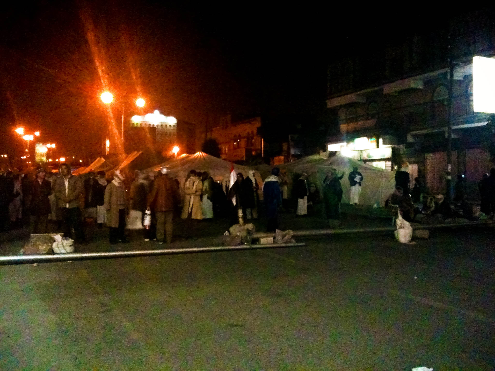 a group of people are gathered near the street