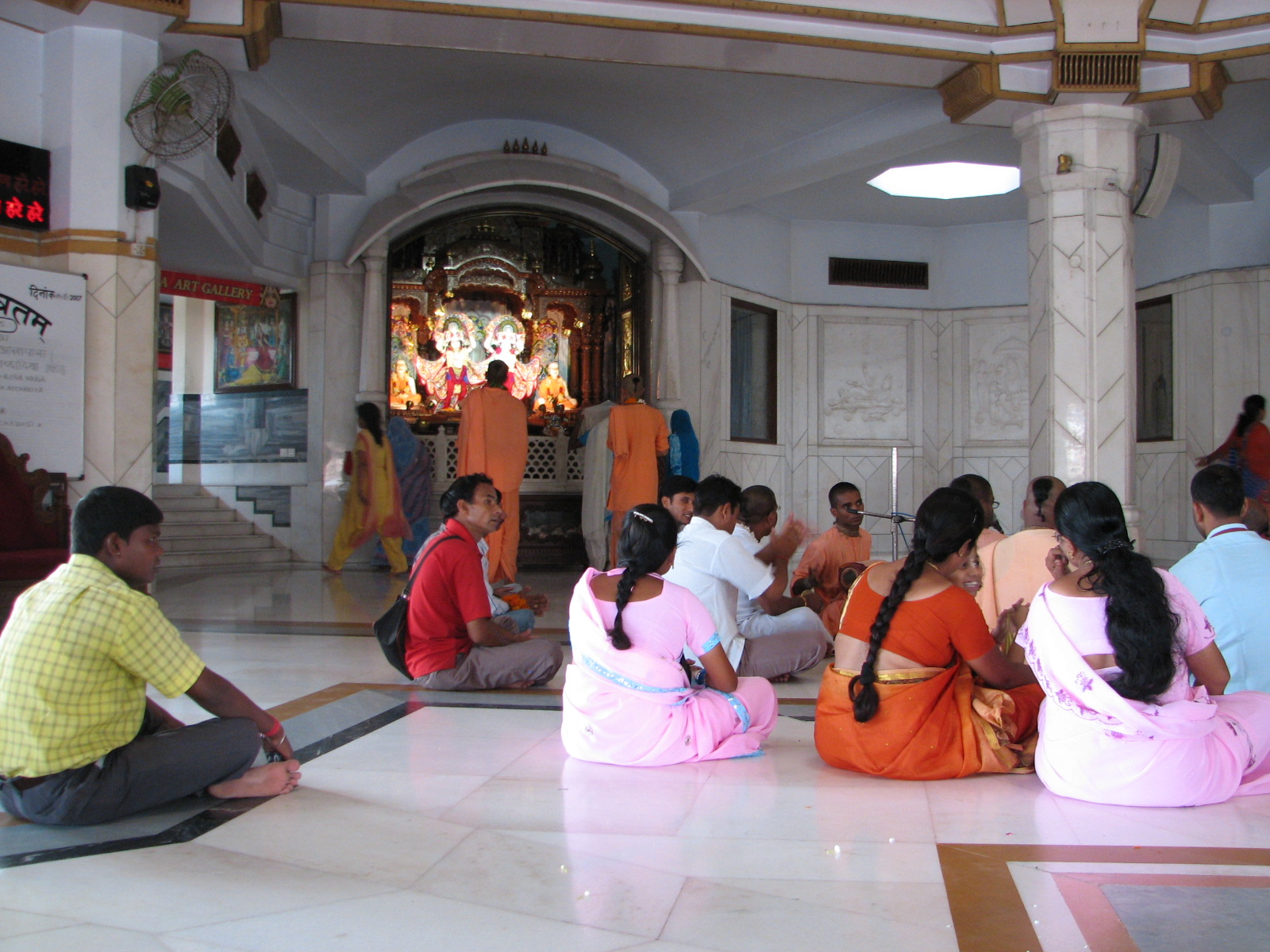 a group of people sitting on the floor in front of a building